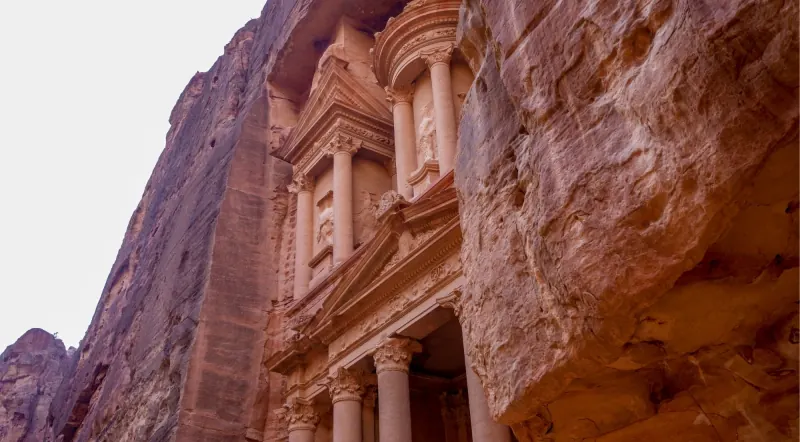Petra's Treasury framed between the sandstone walls of the Siq