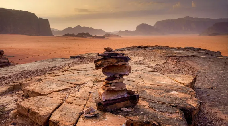 Sunset light over the Wadi Rum desert plain from a rock viewpoint